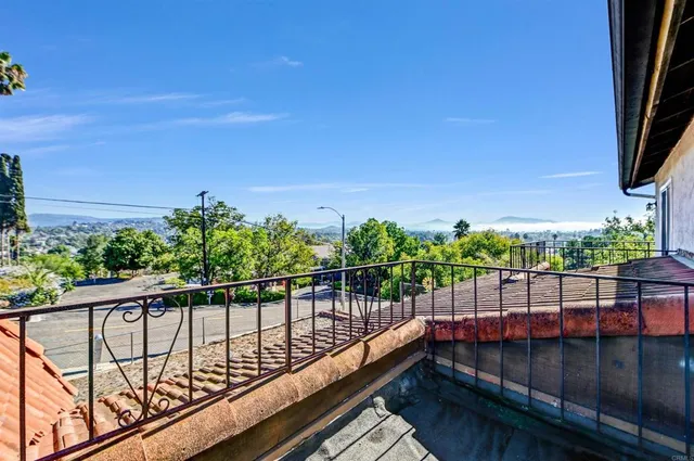 a view of a balcony with wooden floor