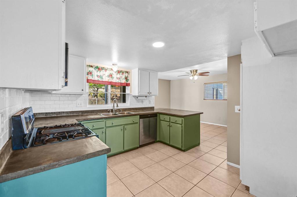 735 South Upas Street Escondido, CA 92025 - Photo 6 of 28 a kitchen with a stove a sink and a refrigerator