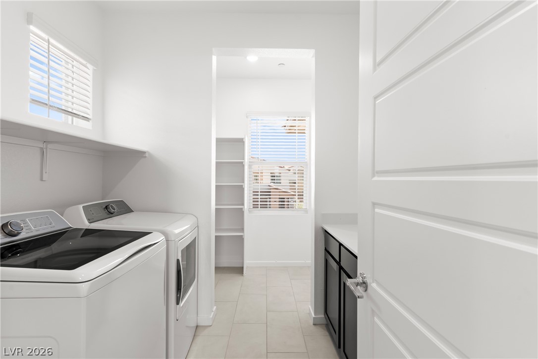 320 Isla Enclave Way Henderson, NV 89011 - Photo 22 of 49 This functional laundry room features convenient shelving and modern appliances for efficient chores.