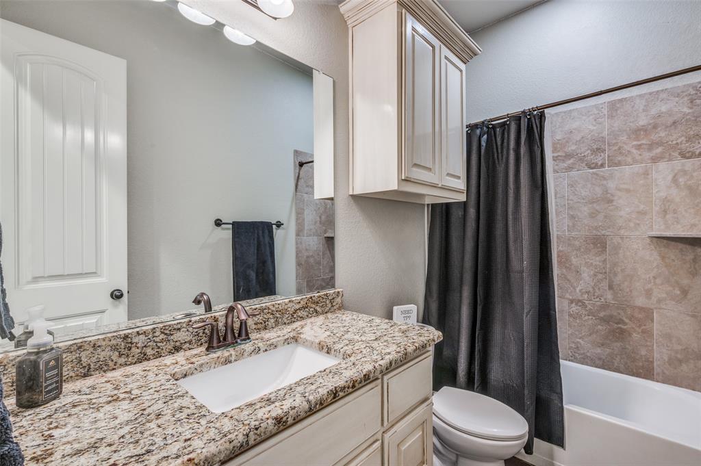 4140 Fm 2450 Krum, TX 76249 - Photo 16 of 28 a bathroom with a granite countertop sink toilet and shower