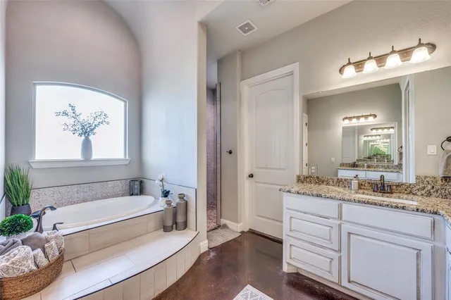 a bedroom with a large bed and ceiling fan