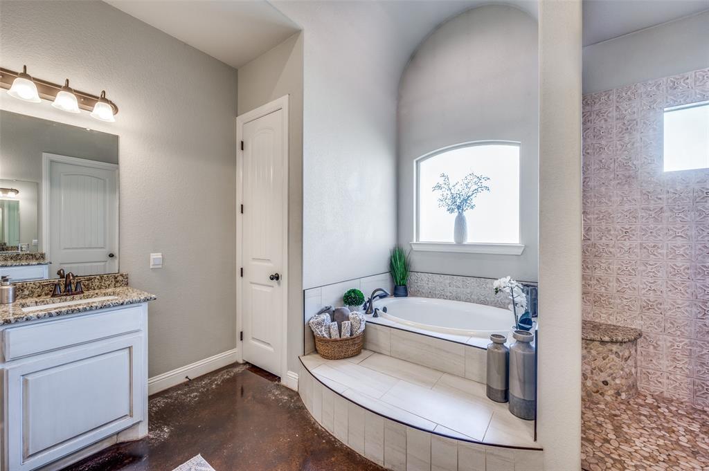 4140 Fm 2450 Krum, TX 76249 - Photo 19 of 28 a bathroom with a granite countertop tub a sink and a window