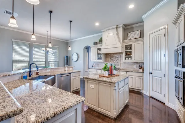 a kitchen with white cabinets and appliances