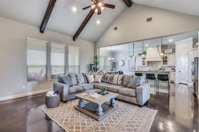 a utility room with stainless steel appliances white cabinets and a window