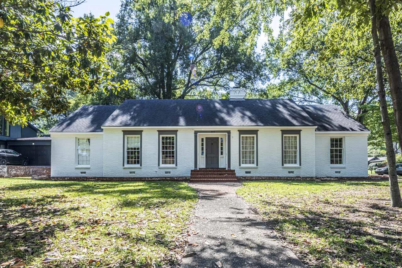 Single story home with brick siding and a front lawn