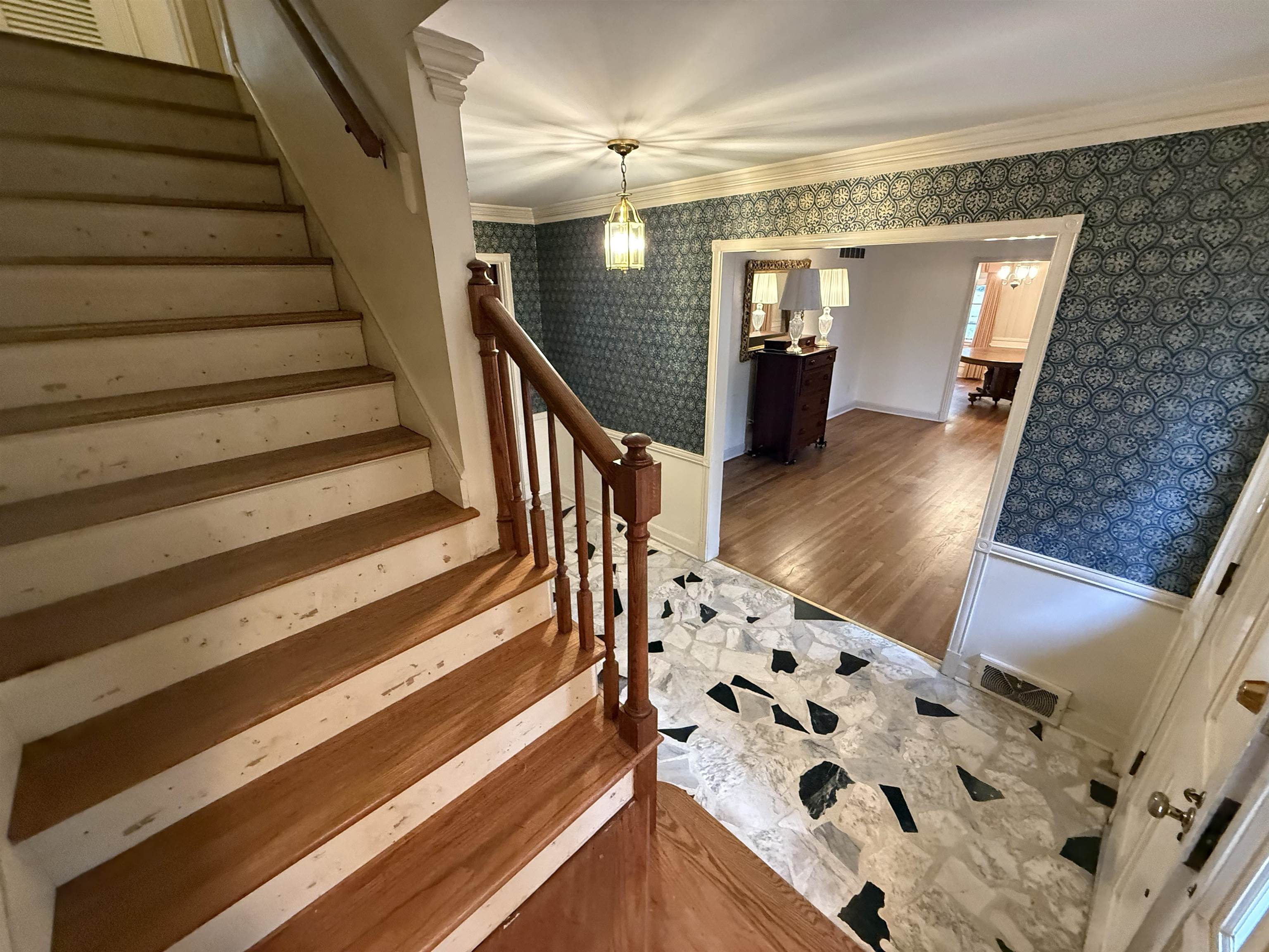 5575 Walnut Grove Road Memphis, TN 38120 - Photo 11 of 36 a view of a hallway with wooden floor and staircase