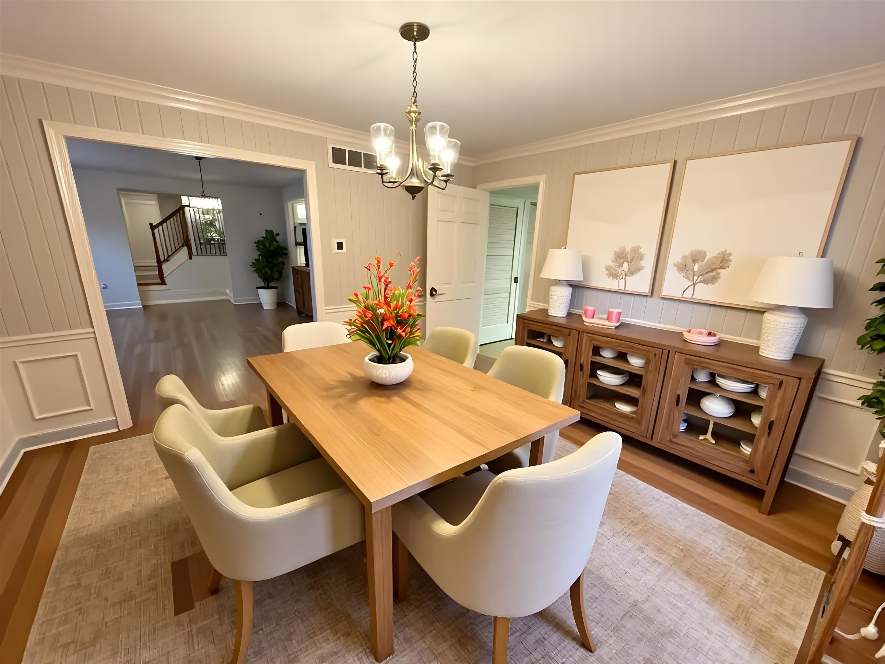 5575 Walnut Grove Road Memphis, TN 38120 - Photo 16 of 36 a view of a dining room with furniture a chandelier and wooden floor