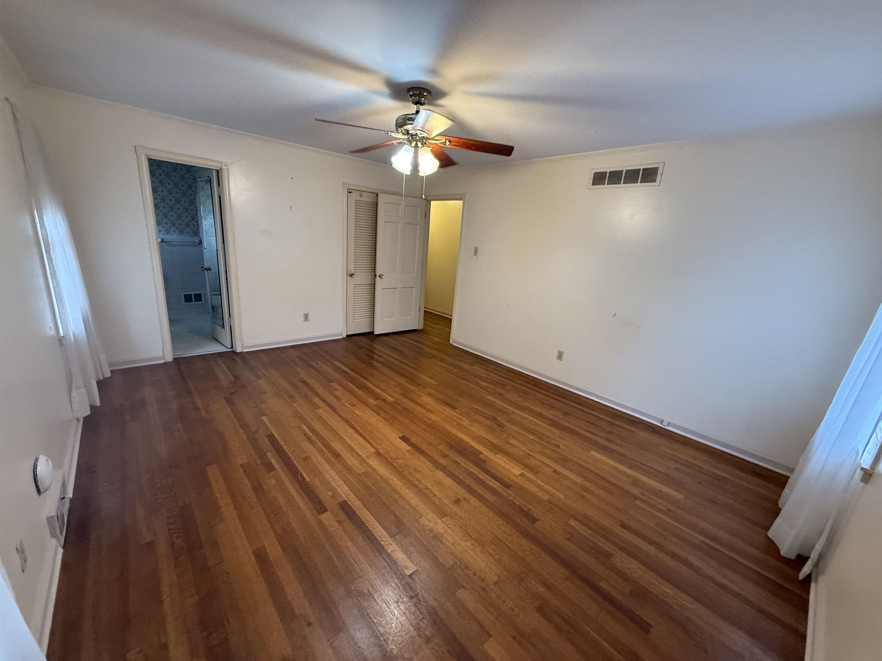 5575 Walnut Grove Road Memphis, TN 38120 - Photo 22 of 36 wooden floor in an empty room with a window