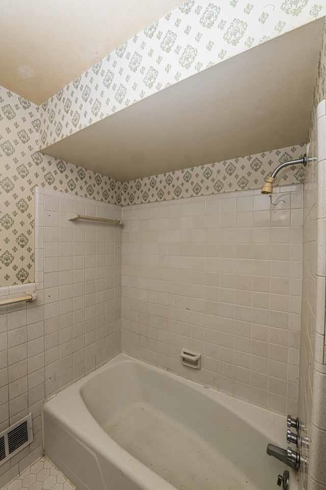 5575 Walnut Grove Road Memphis, TN 38120 - Photo 26 of 36 Bathroom featuring bathtub / shower combination, tile walls, wallpapered walls, and tile patterned floors