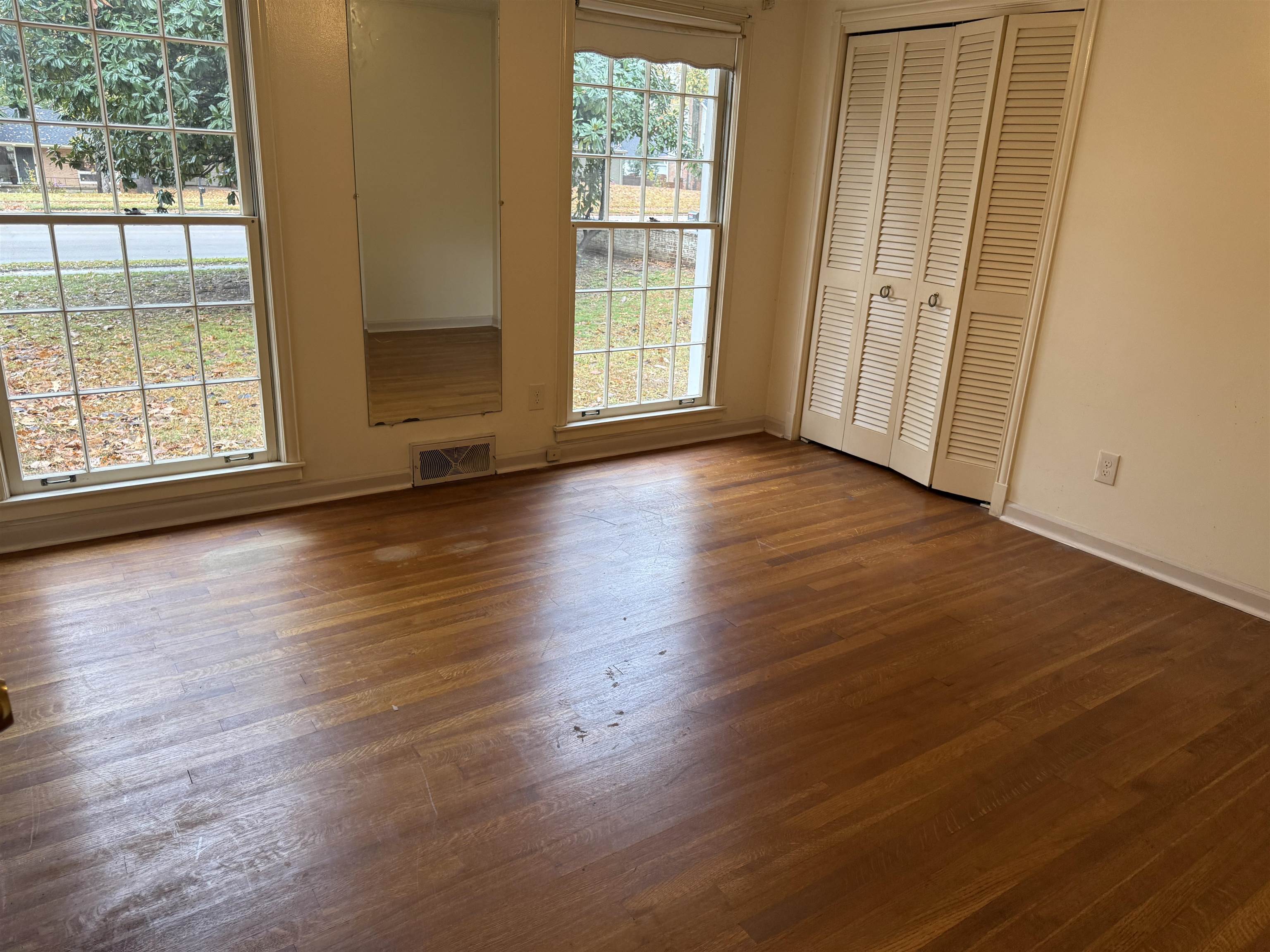 5575 Walnut Grove Road Memphis, TN 38120 - Photo 27 of 36 an empty room with wooden floor and windows