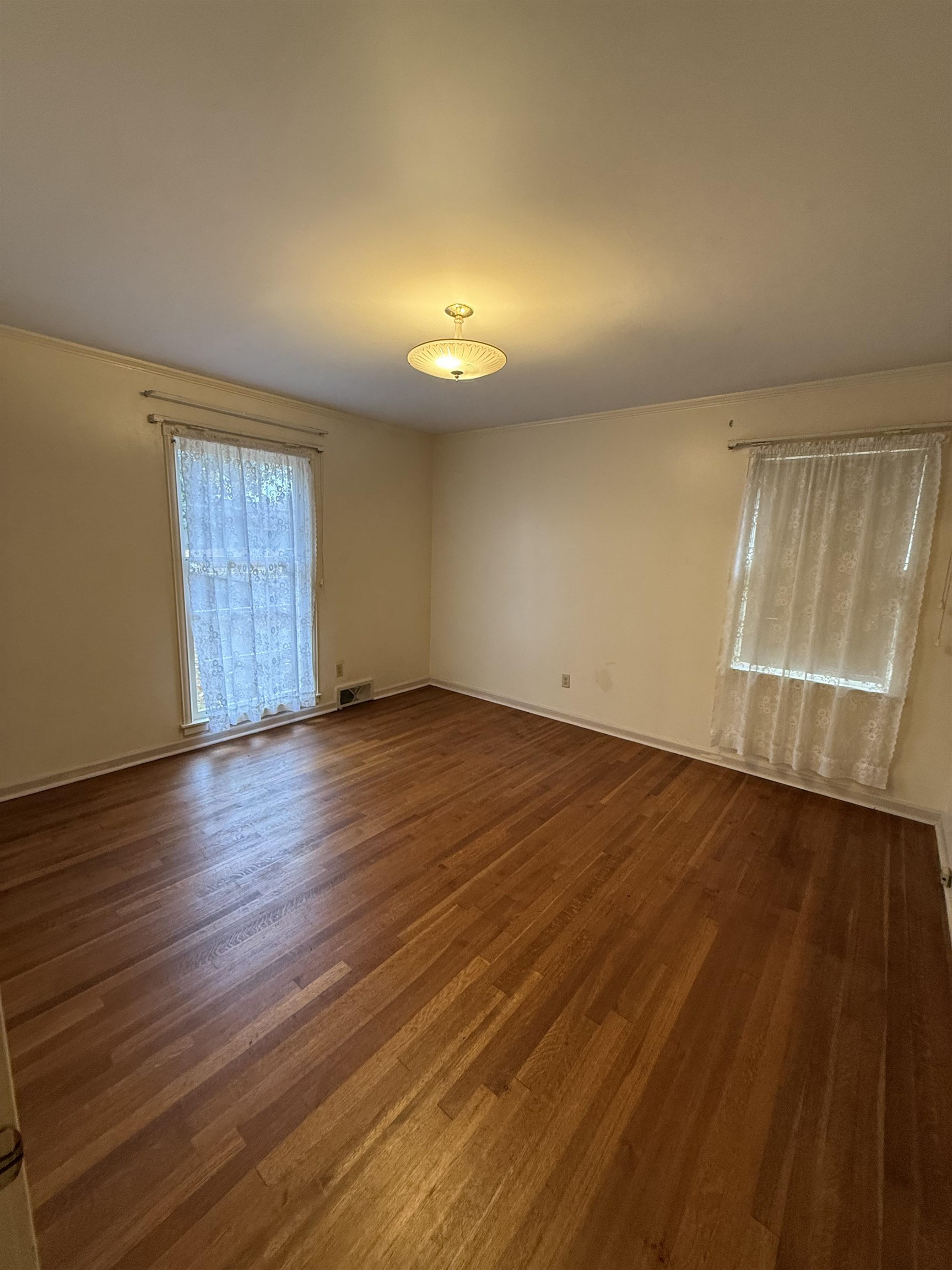 5575 Walnut Grove Road Memphis, TN 38120 - Photo 29 of 36 an empty room with wooden floor and windows