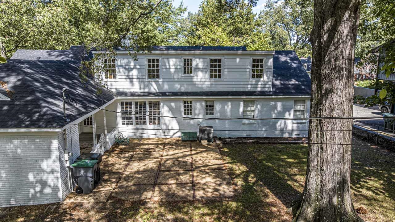 5575 Walnut Grove Road Memphis, TN 38120 - Photo 9 of 36 Back of house featuring a shingled roof and brick siding
