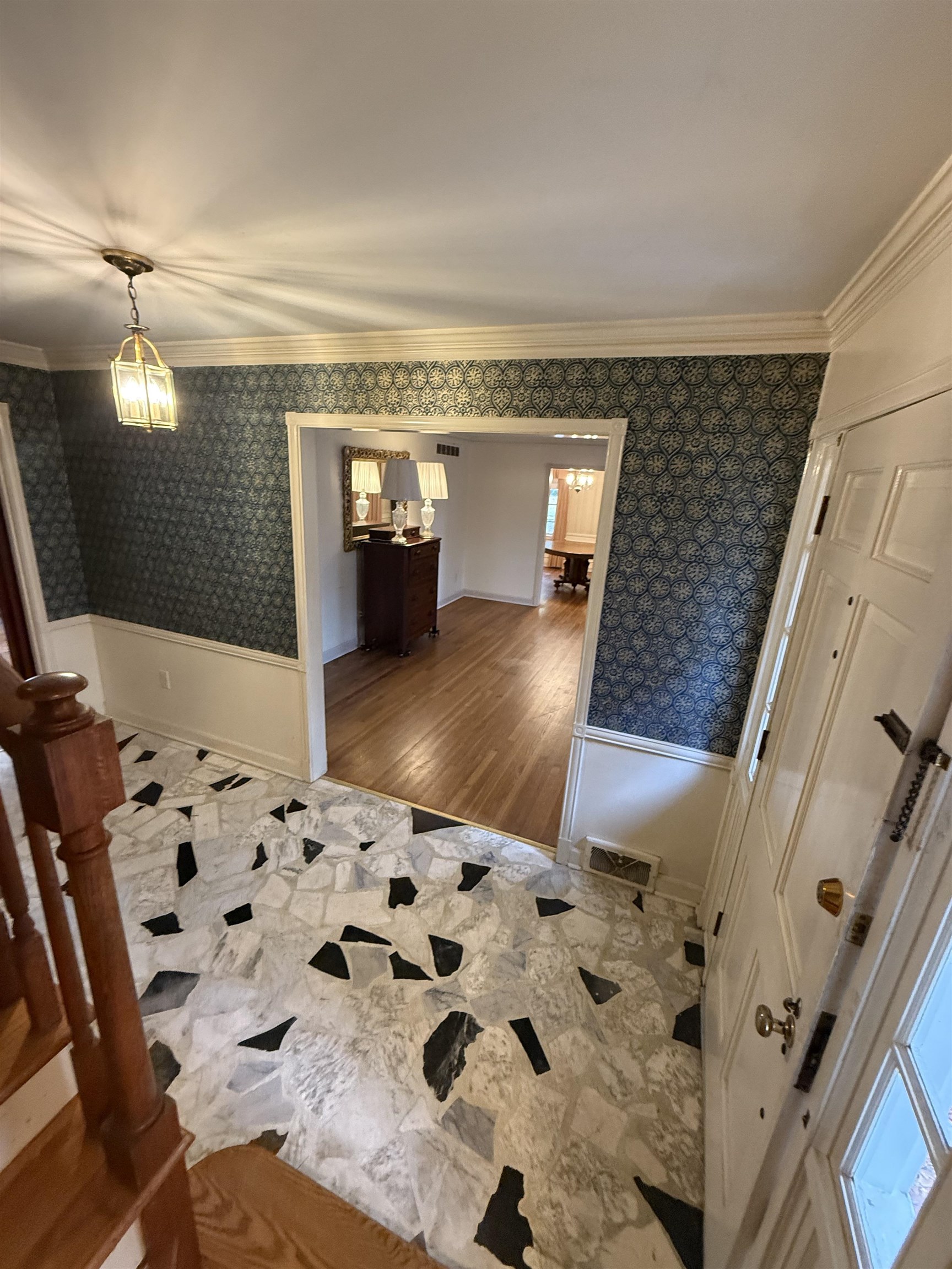 5575 Walnut Grove Road Memphis, TN 38120 - Photo 10 of 36 Hallway with wainscoting, wallpapered walls, ornamental molding, and a chandelier