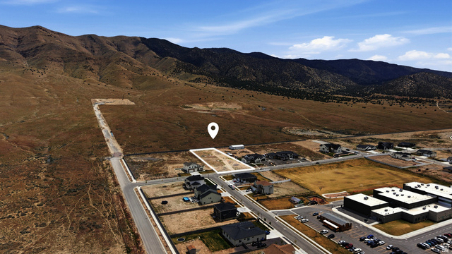 2930 Jojo Road, Unit 110 Eagle Mountain, UT 84005 - Photo 5 of 22 Aerial view of property and surrounding area featuring a mountain backdrop and rural landscape