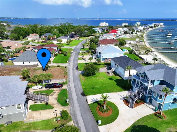 an aerial view of a houses with an outdoor space and seating