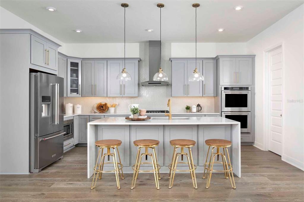 2012 Beach Terrace Celebration, FL 34747 - Photo 6 of 26 a kitchen with stainless steel appliances granite countertop a dining table chairs refrigerator and microwave