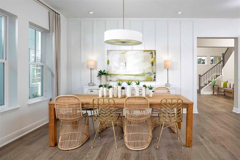 2012 Beach Terrace Celebration, FL 34747 - Photo 7 of 26 a dining room with furniture a chandelier and wooden floor