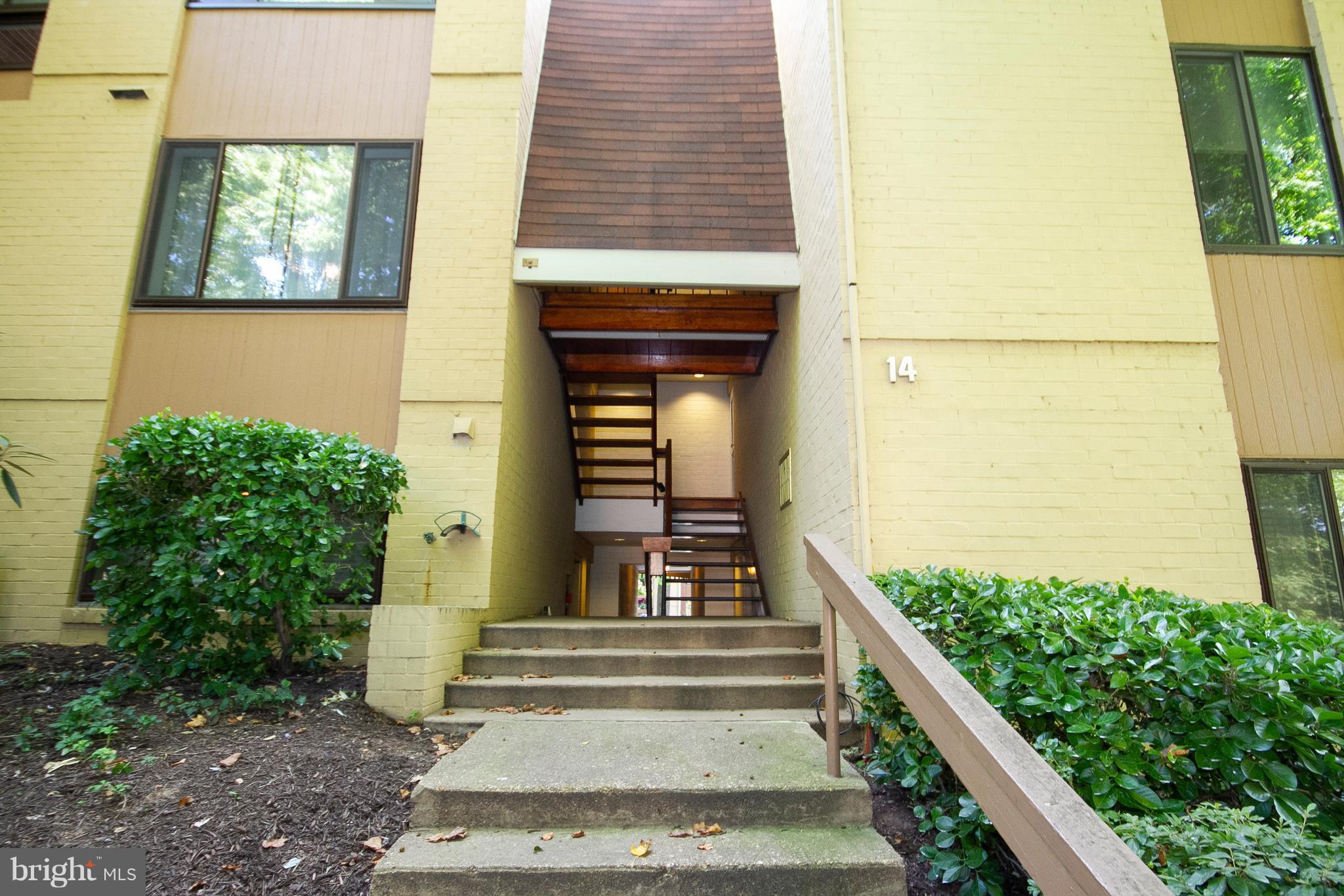 14 Cross Keys Road, Unit 14D Baltimore, MD 21210 - Photo 2 of 25 a front view of a house with a yard
