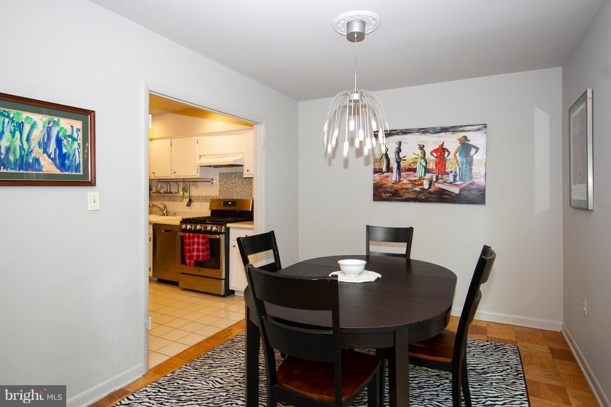 14 Cross Keys Road, Unit 14D Baltimore, MD 21210 - Photo 11 of 25 a view of a dining room with furniture and chandelier