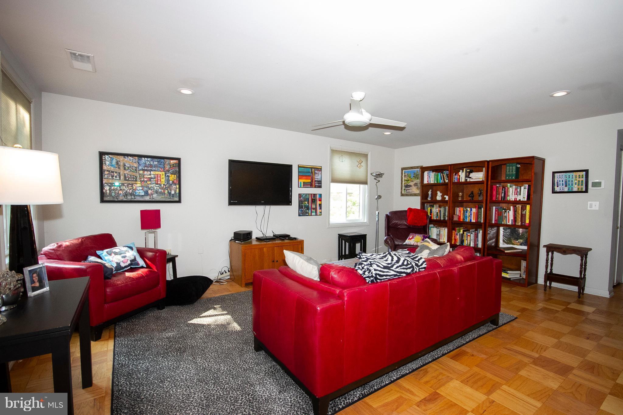 14 Cross Keys Road, Unit 14D Baltimore, MD 21210 - Photo 12 of 25 a living room with furniture and a flat screen tv