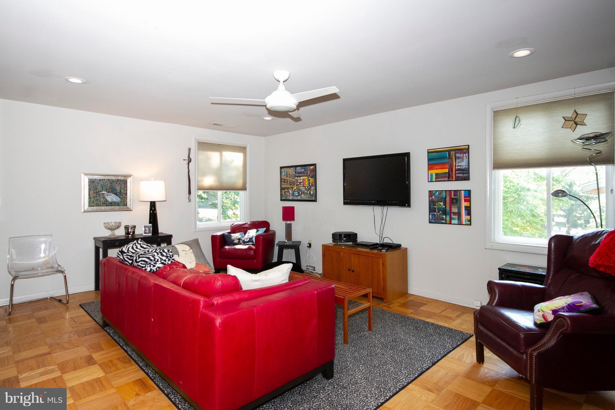 14 Cross Keys Road, Unit 14D Baltimore, MD 21210 - Photo 13 of 25 a living room with furniture and a flat screen tv