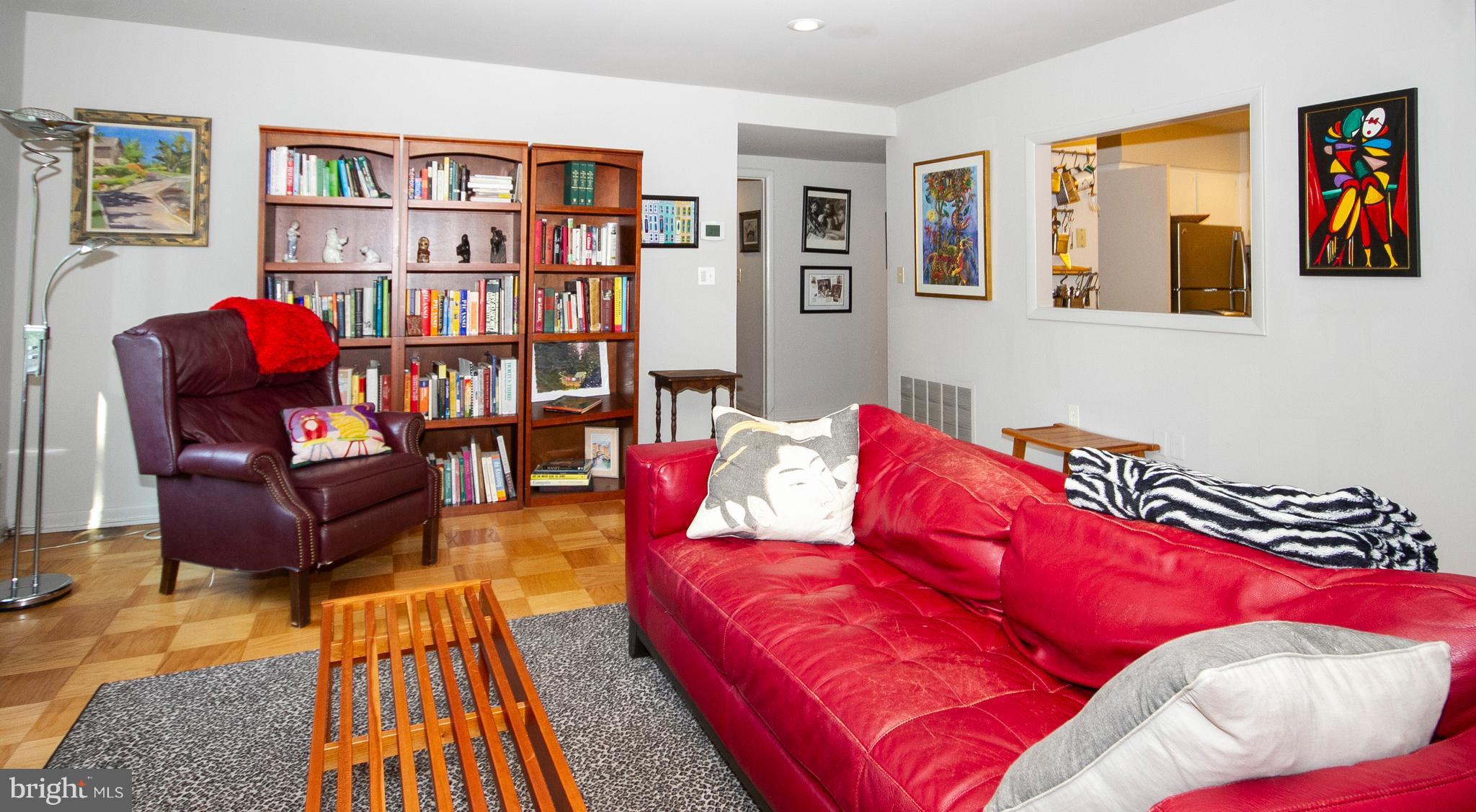 14 Cross Keys Road, Unit 14D Baltimore, MD 21210 - Photo 15 of 25 a living room with furniture and a book shelf