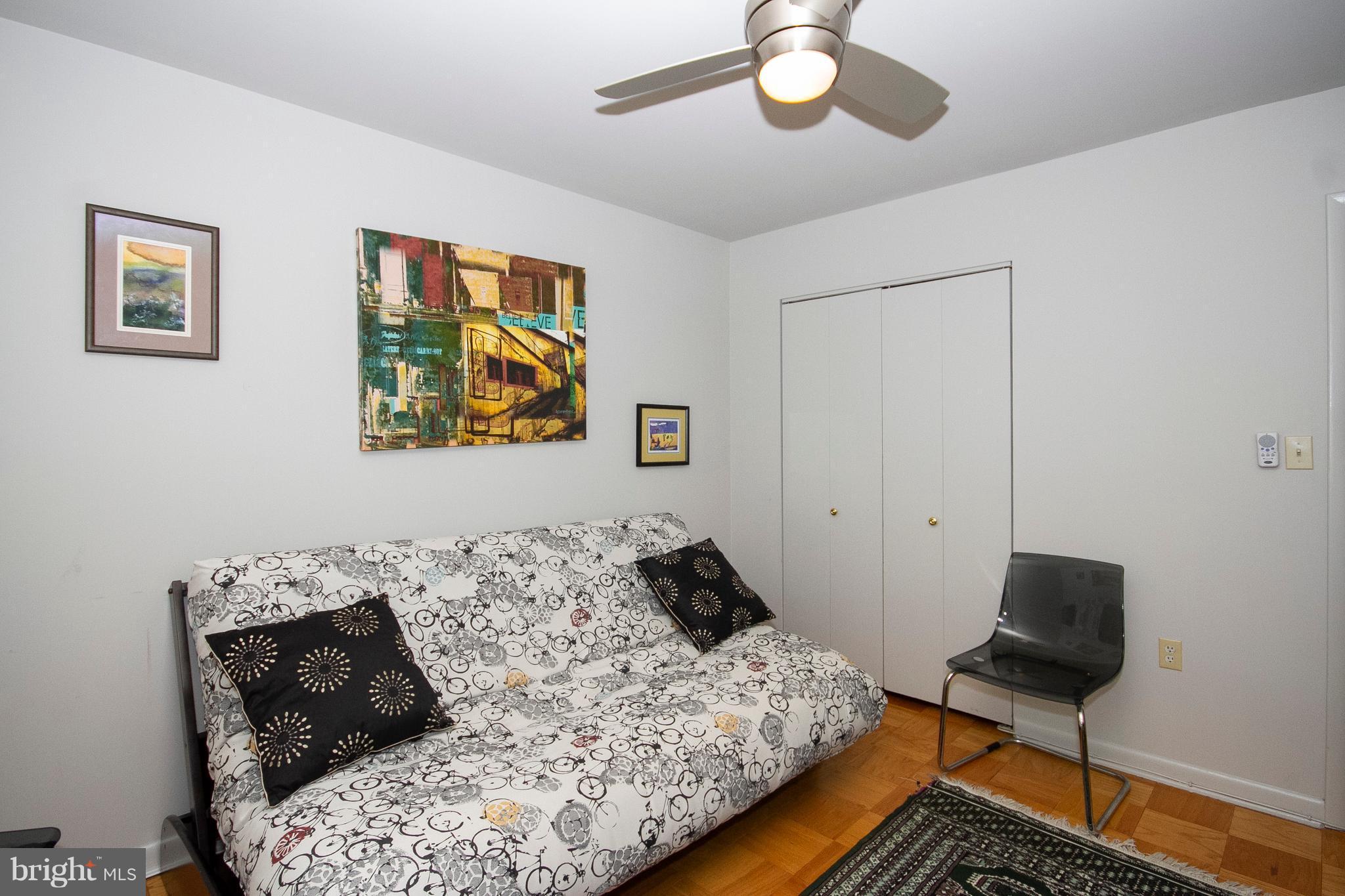 14 Cross Keys Road, Unit 14D Baltimore, MD 21210 - Photo 18 of 25 a bedroom with a bed and wooden floor