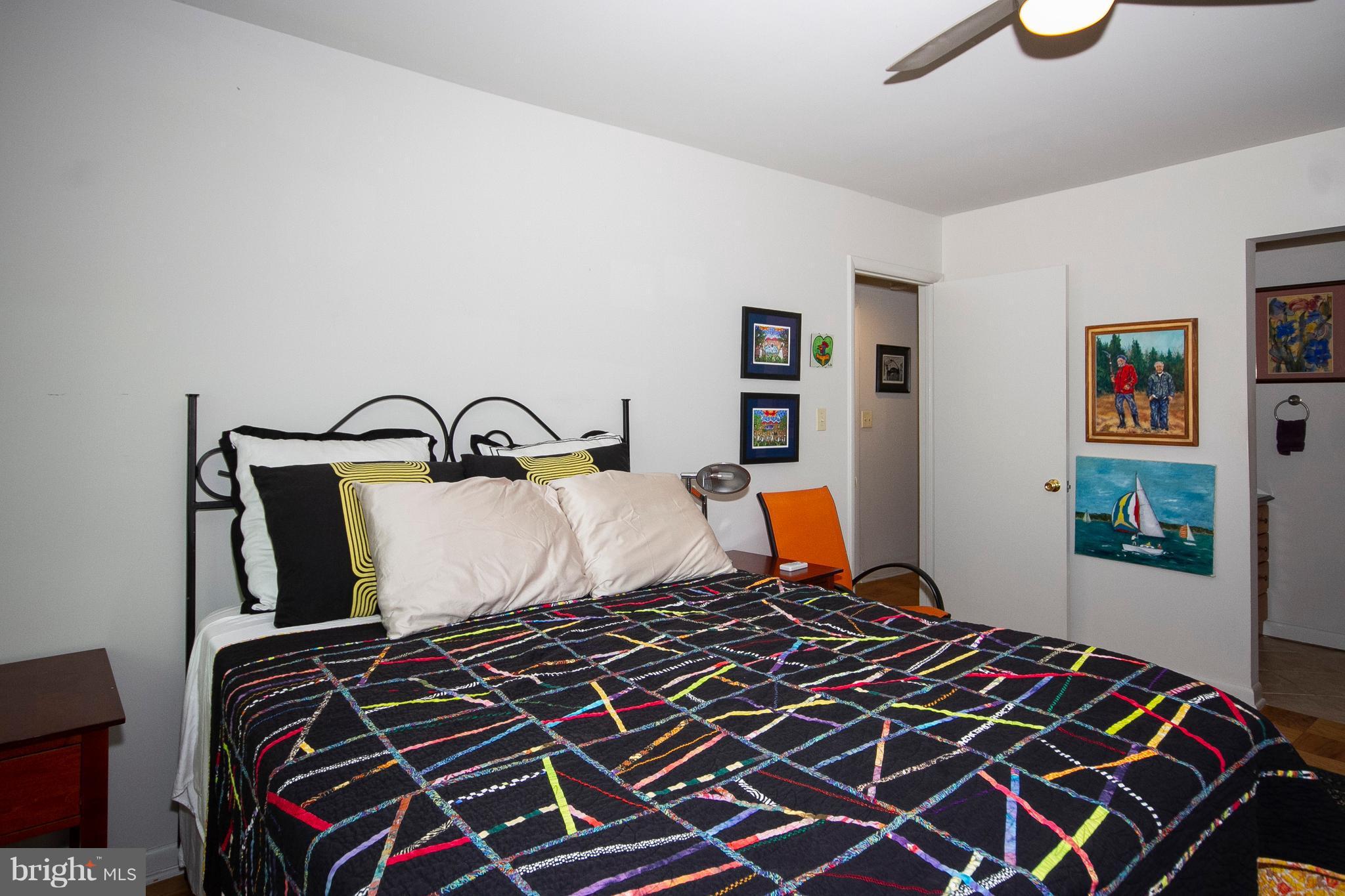 14 Cross Keys Road, Unit 14D Baltimore, MD 21210 - Photo 21 of 25 a bedroom with a bed and wooden floor