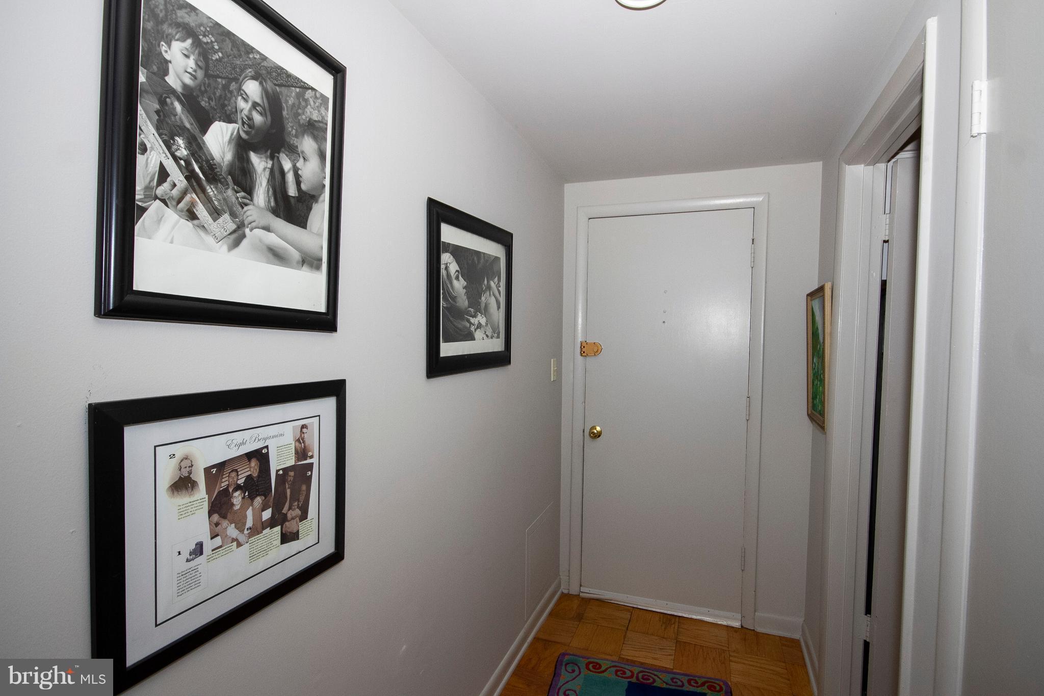 14 Cross Keys Road, Unit 14D Baltimore, MD 21210 - Photo 4 of 25 a view of a hallway with painting on the wall