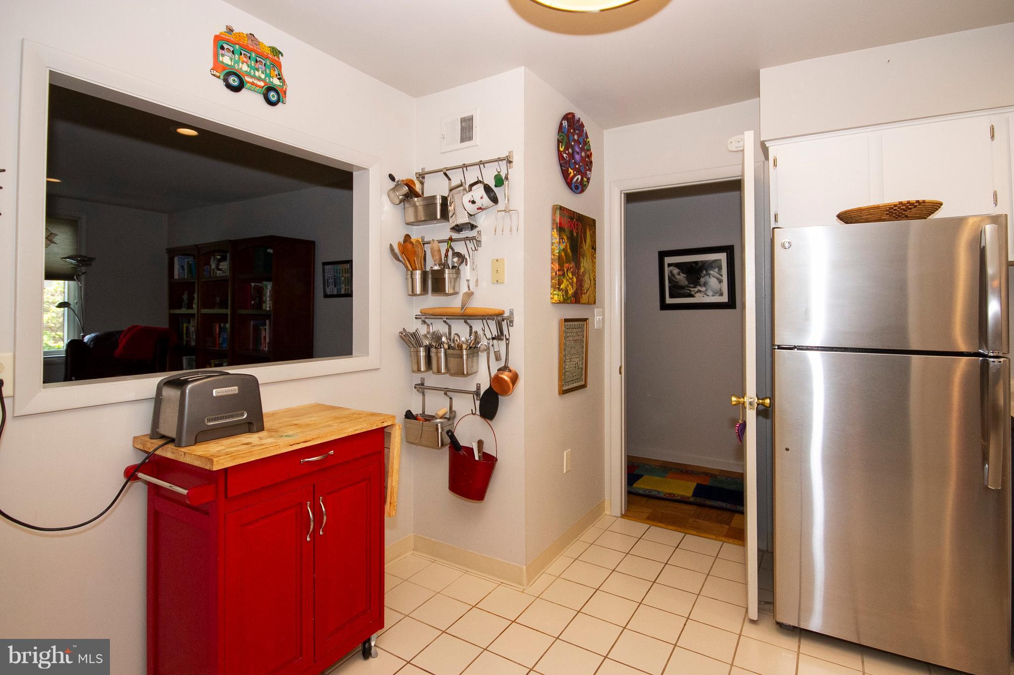 14 Cross Keys Road, Unit 14D Baltimore, MD 21210 - Photo 7 of 25 a kitchen with stainless steel appliances granite countertop a refrigerator and a sink