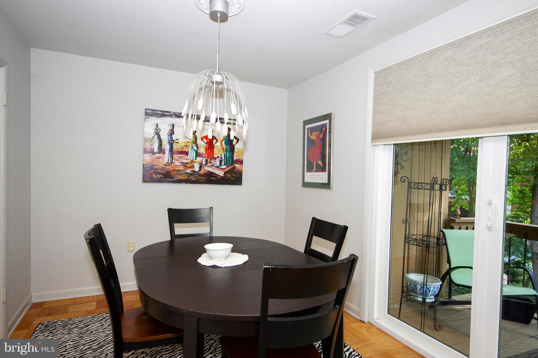 14 Cross Keys Road, Unit 14D Baltimore, MD 21210 - Photo 9 of 25 a view of a dining room with furniture wooden floor and a chandelier