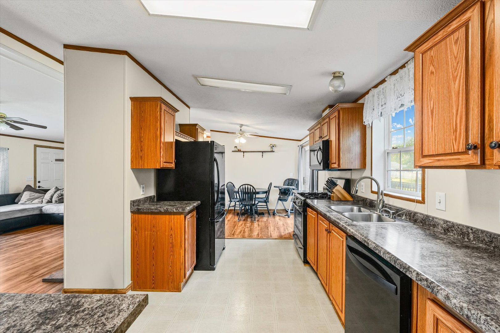 509 West Rhodes Street Thomasboro, IL 61878 - Photo 13 of 29 a kitchen with stainless steel appliances granite countertop a sink stove and refrigerator