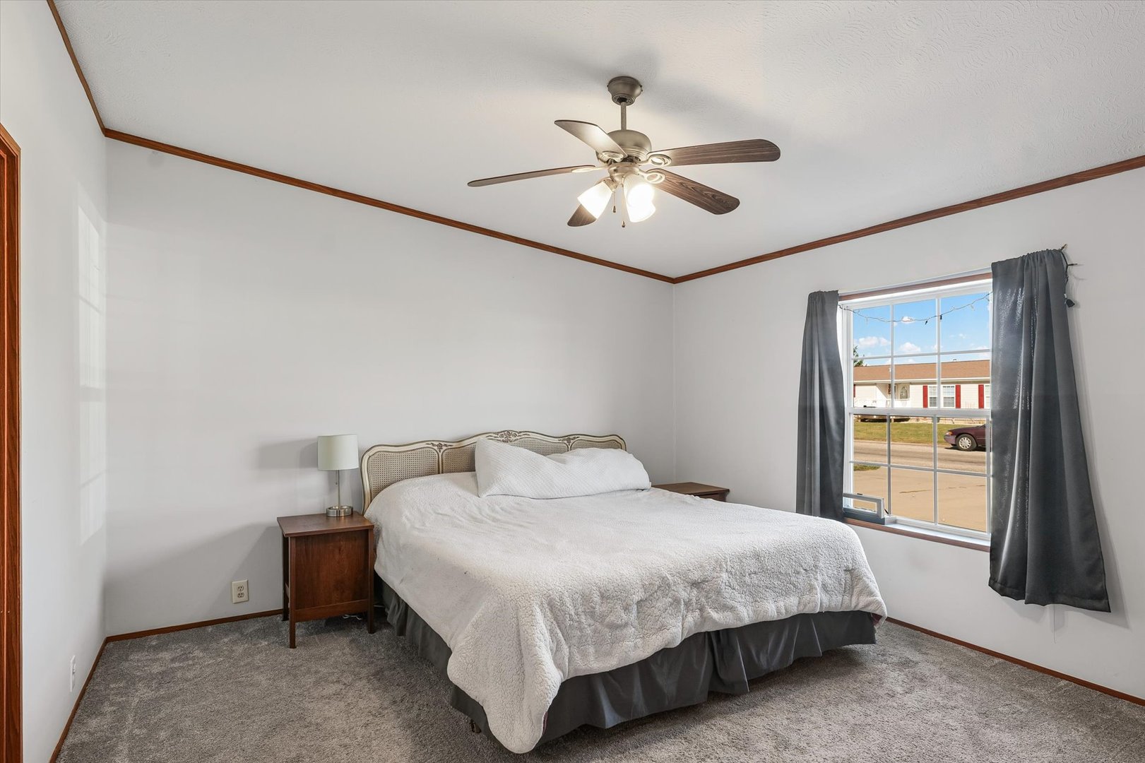 509 West Rhodes Street Thomasboro, IL 61878 - Photo 15 of 29 a bedroom with a bed and a chandelier