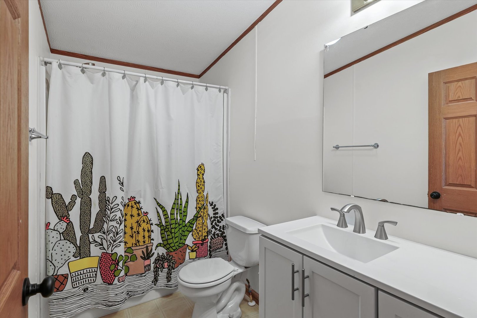 509 West Rhodes Street Thomasboro, IL 61878 - Photo 23 of 29 a bathroom with a granite countertop sink a toilet and a mirror