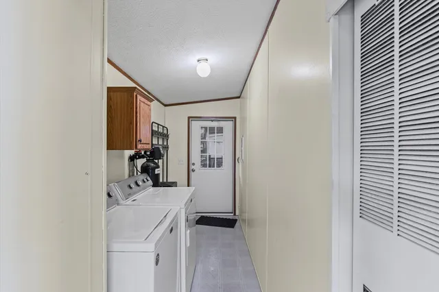 a view of a room that has a bed and a large mirror in it