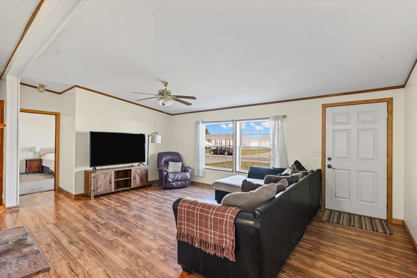 509 West Rhodes Street Thomasboro, IL 61878 - Photo 7 of 29 a living room with furniture a flat screen tv and a large window