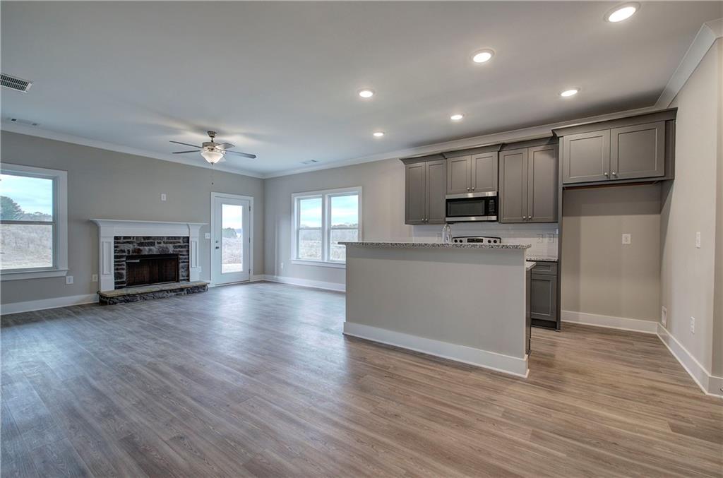201 Daisy Court Cartersville, GA 30121 - Photo 11 of 36 a view of a kitchen with a sink a refrigerator and a fireplace