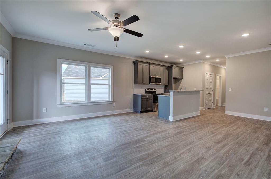 201 Daisy Court Cartersville, GA 30121 - Photo 12 of 36 an open kitchen with a refrigerator stove microwave and cabinets