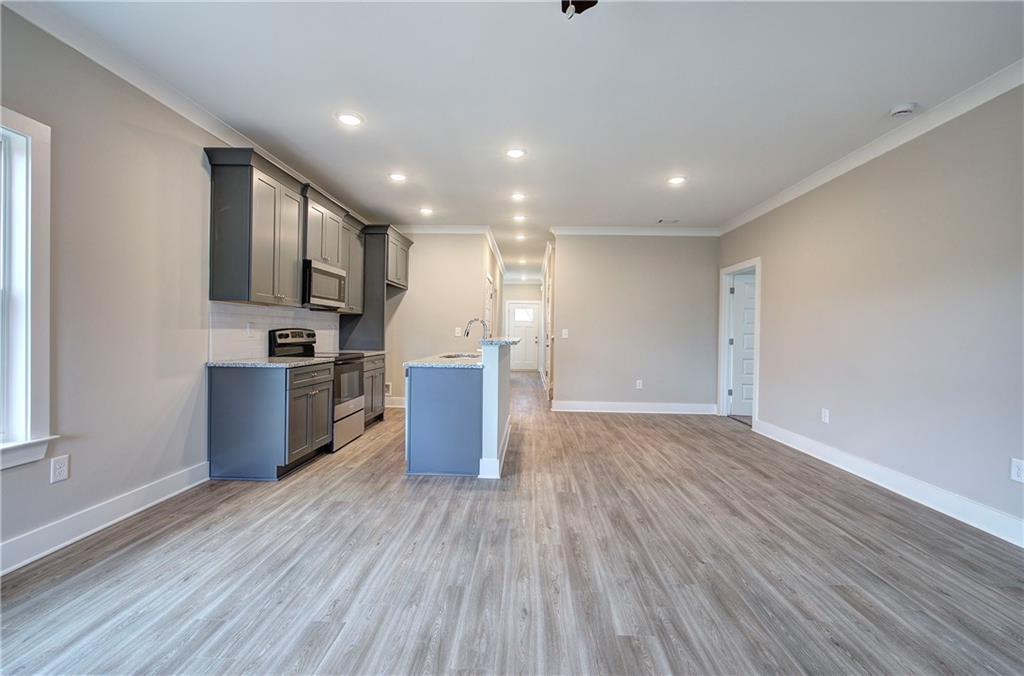 201 Daisy Court Cartersville, GA 30121 - Photo 13 of 36 a view of kitchen with microwave refrigerator and wooden floor