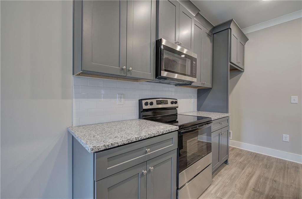 201 Daisy Court Cartersville, GA 30121 - Photo 16 of 36 a kitchen with stainless steel appliances granite countertop a sink stove and microwave