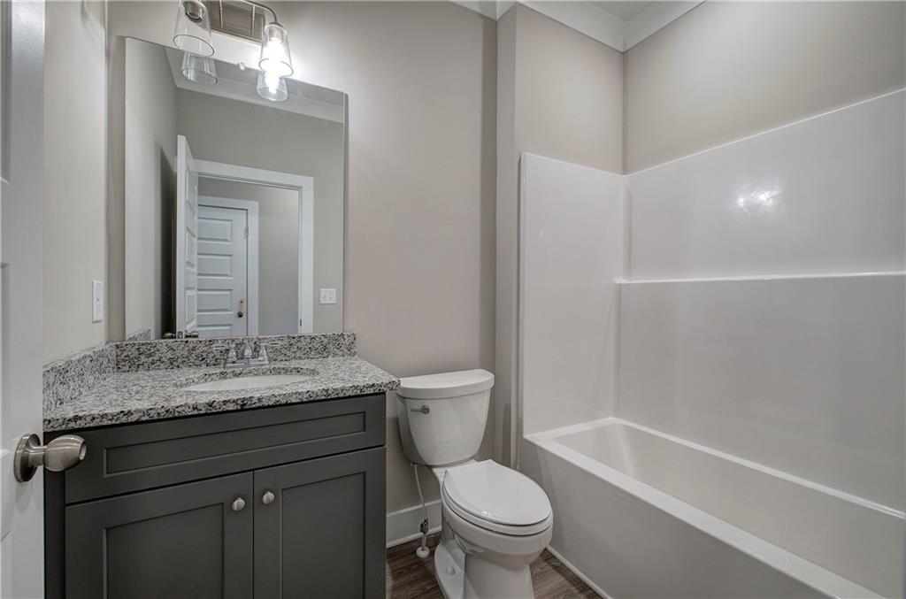 201 Daisy Court Cartersville, GA 30121 - Photo 27 of 36 a bathroom with a granite countertop sink toilet and shower