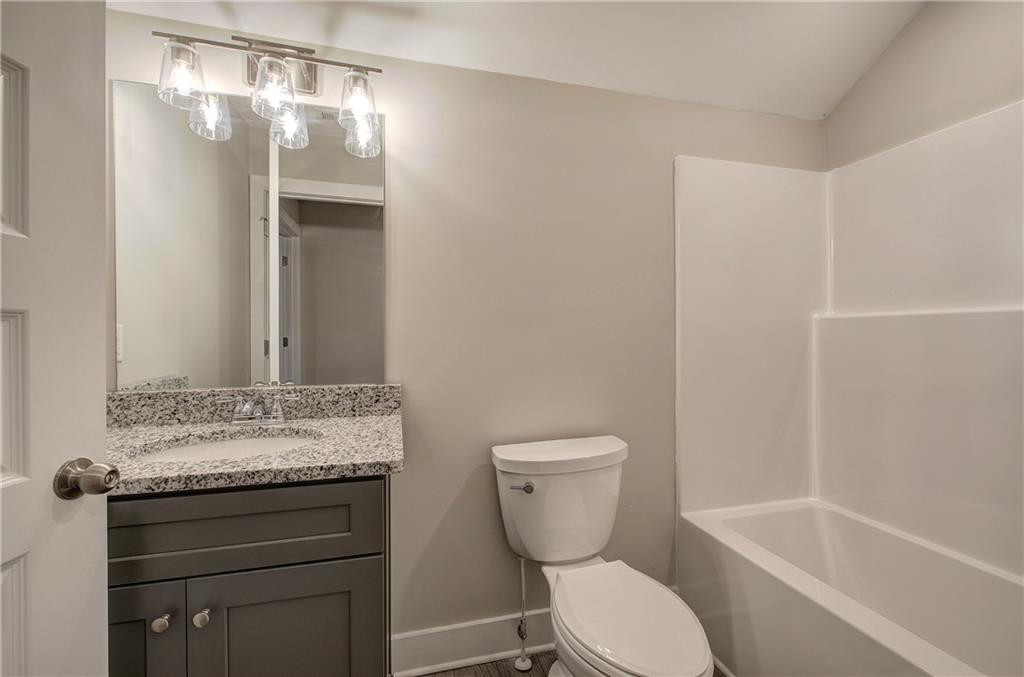 201 Daisy Court Cartersville, GA 30121 - Photo 30 of 36 a bathroom with a granite countertop sink toilet and shower