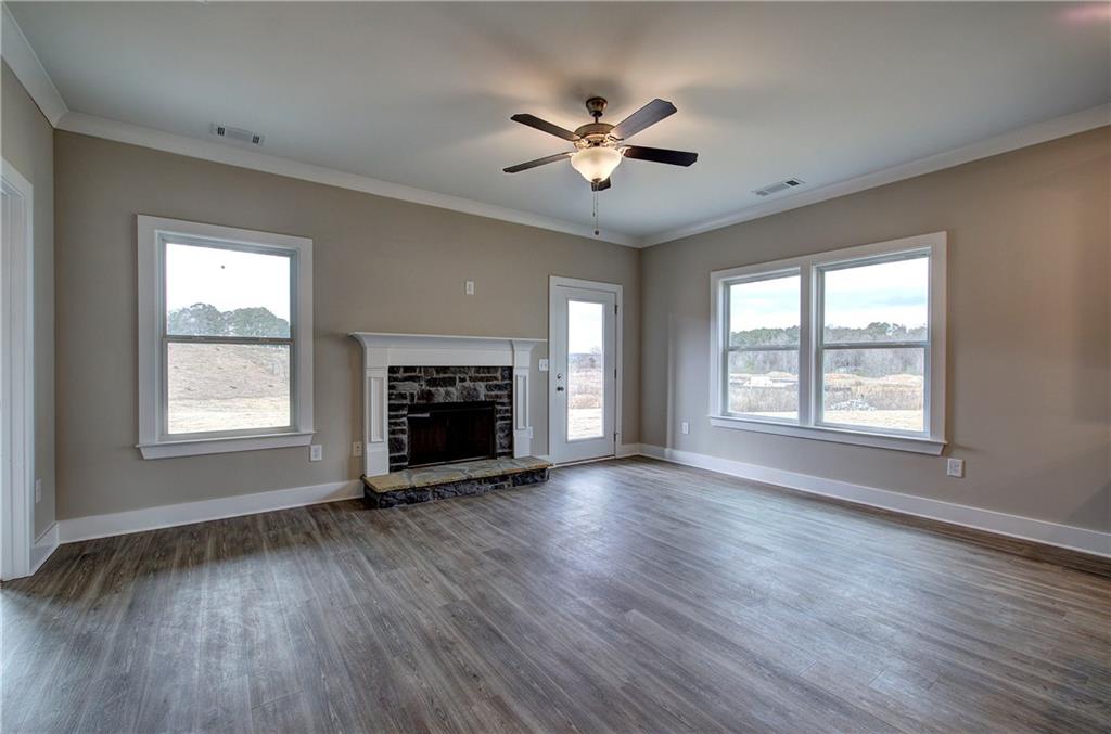 201 Daisy Court Cartersville, GA 30121 - Photo 5 of 36 wooden floor fireplace and windows in an empty room