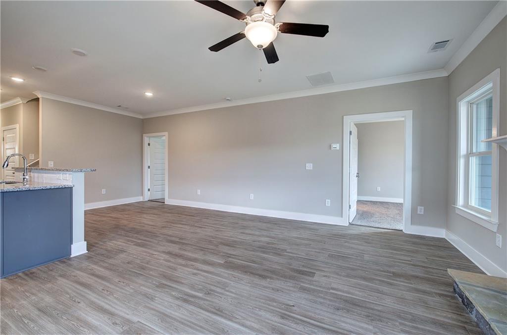 201 Daisy Court Cartersville, GA 30121 - Photo 6 of 36 a view of an empty room with window and wooden floor