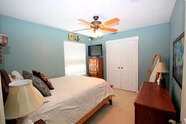 a bedroom with a bed and a chandelier