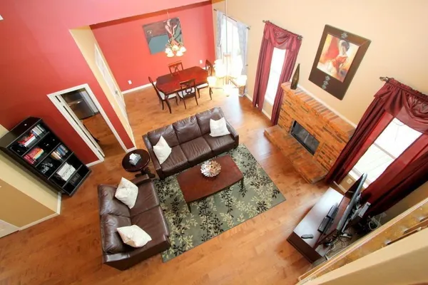 a living room with furniture and a floor to ceiling window