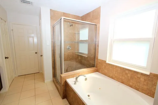a bathroom with a tub and shower