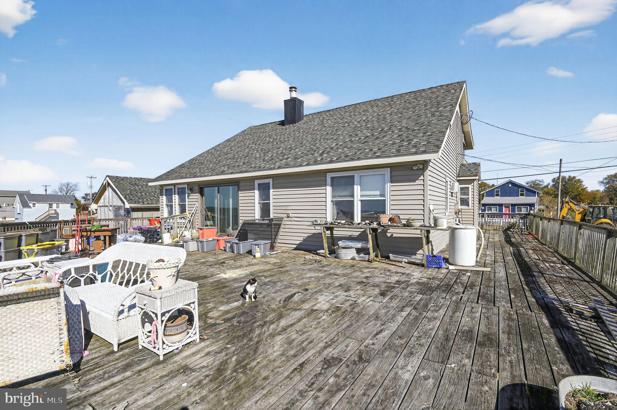 114 Delaware Avenue Fortescue, NJ 08321 - Photo 11 of 27 a view of a house with wooden deck and furniture