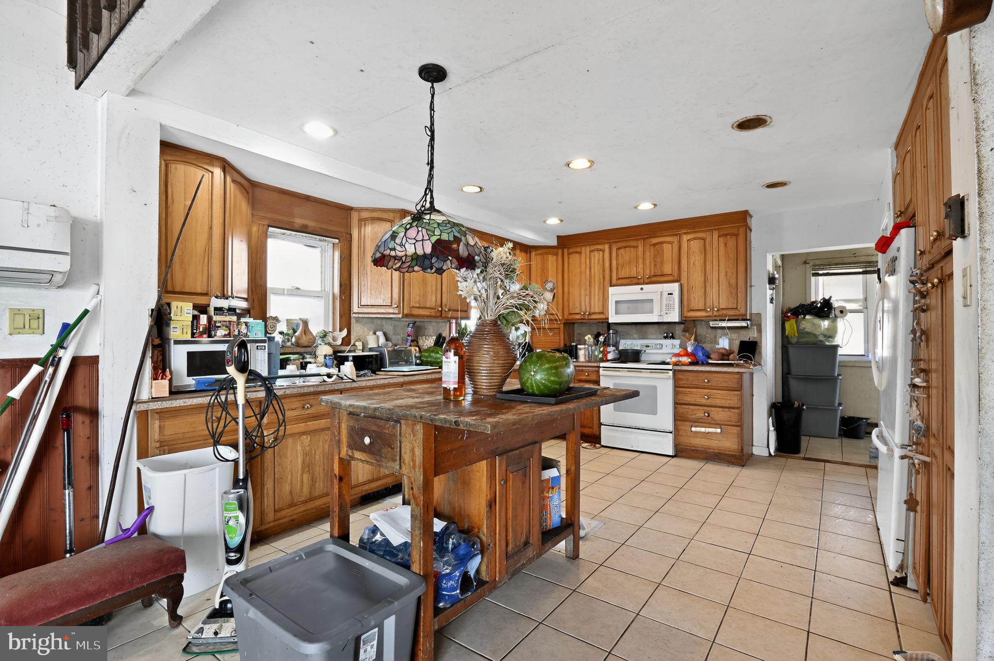 114 Delaware Avenue Fortescue, NJ 08321 - Photo 21 of 27 a kitchen with stainless steel appliances granite countertop a refrigerator and a stove top oven