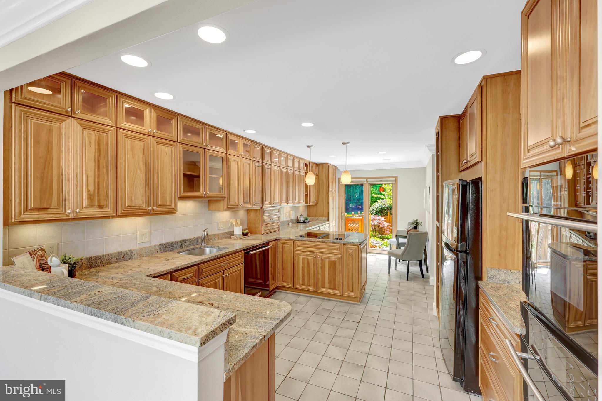 11064 Thrush Ridge Road Reston, VA 20191 - Photo 14 of 85 a kitchen with stainless steel appliances granite countertop a refrigerator a sink a stove and a cabinets